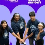 Four smiling teens in matching navy blue shirts stand in a circle, stacking their hands together. The purple background features the Oregon MESA's 2025 Annual Report logo and text.