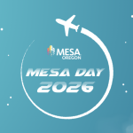 Airplane flying above a circular logo with “MESA Oregon” and “MESA Day 2026” on a blue sky background with stars and clouds.